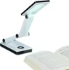 A white LED desk lamp with a black trim is shown in a studio setting next to an open book. Produktbild-Vorschau
