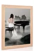 A woman in a white dress plays a piano in a misty, rocky landscape. Produktbild-Vorschau