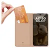 A hand is inserting a credit card into a pink phone case that is open like a book. The phone screen shows the Samsung A17 5G logo and an armadillo. Produktbild-Vorschau