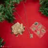 A collection of Harry Potter themed items, including a necklace, a puzzle piece, and stickers, arranged on a red background with hints of a Christmas tree. Náhled obrázku produktu