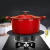A red pot sits on a black stove burner with a black heat diffuser plate. Produktbild-Vorschau