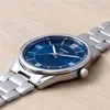 A close-up shot of a Casio watch with a blue dial and silver band, placed on a wooden surface. Podgląd zdjęcia produktu
