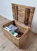 An open wooden chest with a puzzle and some fabric inside, placed on a wooden floor. Náhled obrázku produktu