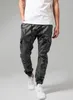 A person is standing and posing in front of a plain background, wearing the product. Produktbild-Vorschau