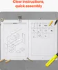 An open instruction manual for a desk bookshelf, with assembly parts and tools scattered around. Voir les images du produit