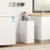 A white narrow cabinet is placed next to a white chest freezer in a kitchen or bathroom setting. Podgląd zdjęcia produktu