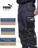 A person wearing Puma Workwear pants, with feature callouts. Produktbild-Vorschau