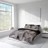 A bedroom with a bed featuring a duvet cover with a cat print, large window, and a nightstand. Produktbild-Vorschau