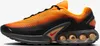 A side view of a Nike Air Max Dn SE sneaker in orange and black. Produktbild-Vorschau