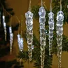 Close-up of decorative icicle lights hanging on a Christmas tree. Produktbild-Vorschau