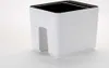 A white planter with a cutout for cables sits on a white surface. Náhled obrázku produktu