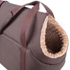 A close-up view of the opening of a brown pet carrier bag with a tan, fuzzy interior. Produktbild-Vorschau
