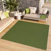 An outdoor patio setting with furniture and a rug. Produktbild-Vorschau