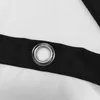 A close-up view of a grommet on a black fabric strip, which is attached to a white surface. Produktbild-Vorschau