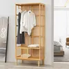 A wooden garment rack with clothes hanging on it, placed in a room next to a mirror and a doorway leading to another room. Podgląd zdjęcia produktu