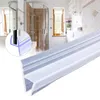 A close-up of a shower door seal in the foreground, with a blurred background of a modern bathroom and shower. Náhľad obrázku produktu