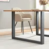 A close-up view of a dining table with a black metal leg and a beige chair in the background. Produktbild-Vorschau