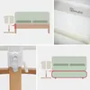 Collage of images showing a baby crib attachment to a bed, close-up of the attachment mechanism, and a diagram of its placement. Produktbild-Vorschau