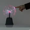 A hand touching a plasma ball, showing the electrical currents reacting to the touch. Podgląd zdjęcia produktu