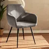 A gray corduroy armchair with black legs is placed on a woven rug, with sunlight casting striped shadows across the floor and the chair. Náhľad obrázku produktu