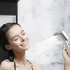 A woman is enjoying a shower with a handheld showerhead. Náhľad obrázku produktu