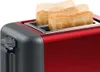 A close-up of a red toaster with toast popping up. Voir les images du produit
