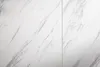 A close-up view of a white marble-patterned surface, likely a tabletop or countertop. Produktbild-Vorschau
