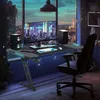 A gaming desk setup in a room with a city view at night. Produktbild-Vorschau