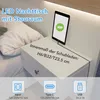 A bedside table with a tablet charging on it, next to a bed. Produktbild-Vorschau