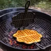 A waffle iron is being used on a grill to cook a waffle. Produktbild-Vorschau