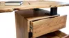 A close-up view of a wooden desk with an open drawer. Produktbild-Vorschau