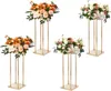 Four gold-colored metal flower stands with floral arrangements on top, arranged in a grid on a white background. Voir les images du produit