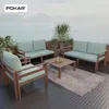 An outdoor patio set with light blue cushions on a wooden deck overlooking a body of water and mountains. Produktbild-Vorschau