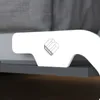 A close-up view of a white bracket with a logo on it, attached to a piece of furniture. Náhled obrázku produktu