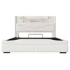 A white upholstered bed frame with a storage headboard is shown against a white background. Podgląd zdjęcia produktu