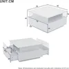 Diagrams showing the dimensions of a white coffee table with drawers and a transparent display area. Voir les images du produit