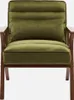 A studio shot of a green velvet armchair with wooden legs. Produktbild-Vorschau