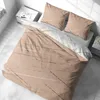A neatly made bed with beige and white striped bedding, two pillows, and a bedside table. Produktbild-Vorschau