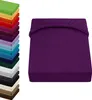 A stack of colorful fitted sheets is shown on the left, with a single purple fitted sheet prominently displayed on the right. Produktbild-Vorschau