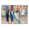 A person is holding a steam mop in front of a bookshelf. Voir les images du produit