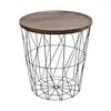 A round wooden tabletop sits atop a black wireframe basket base, presented against a white background. Produktbild-Vorschau