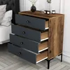 A chest of drawers next to a bed in a bedroom setting. Náhled obrázku produktu