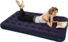 A woman reading on a navy blue air mattress. Náhled obrázku produktu