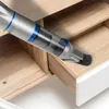 A handheld vacuum cleaner is being used to clean inside an open wooden drawer. Náhled obrázku produktu