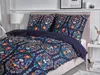 A bed with a duvet and pillows featuring a dark blue and orange floral pattern. Náhled obrázku produktu