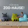 A child sits on a beanbag chair reading a book, surrounded by other animal-themed beanbag chairs and colorful balls. Podgląd zdjęcia produktu