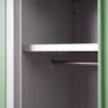 Interior view of a green metal locker with a shelf and a hanging rod. Produktbild-Vorschau