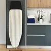 A laundry room setting with an ironing board and folded towels. Produktbild-Vorschau