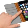 A hand is shown interacting with a smartphone in a wallet-style case. Produktbild-Vorschau