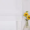 A white Roman blind is shown partially drawn, with two sunflowers in a vase to the right. Produktbild-Vorschau